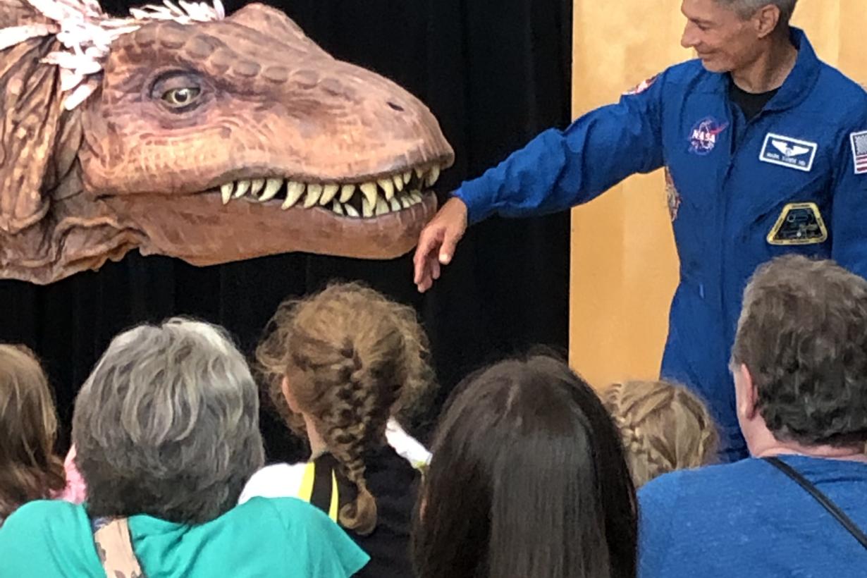 NASA Astronaut Mark Vande Hei at Science Museum of Minnesota 2019 Moon Landing anniversary event with giant dinoaur T-Rex puppet