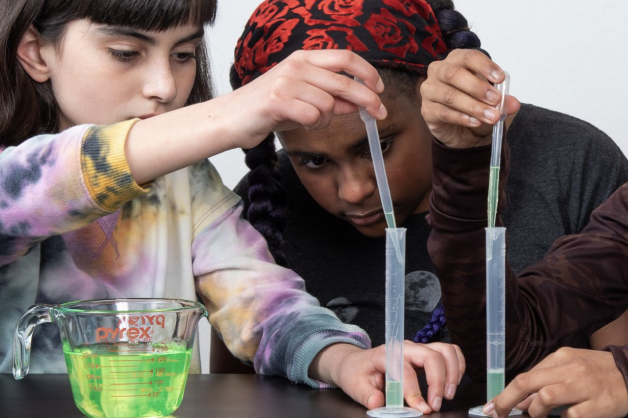 Voyage through the Solar System Breath of Fresh Air activity with children measuring liquid droppers with graduated cylinders