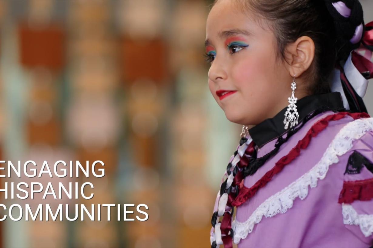 Title image from video, left reads Engaging Hispanic Communities with a young individual in traditional ballet folklorico dress.