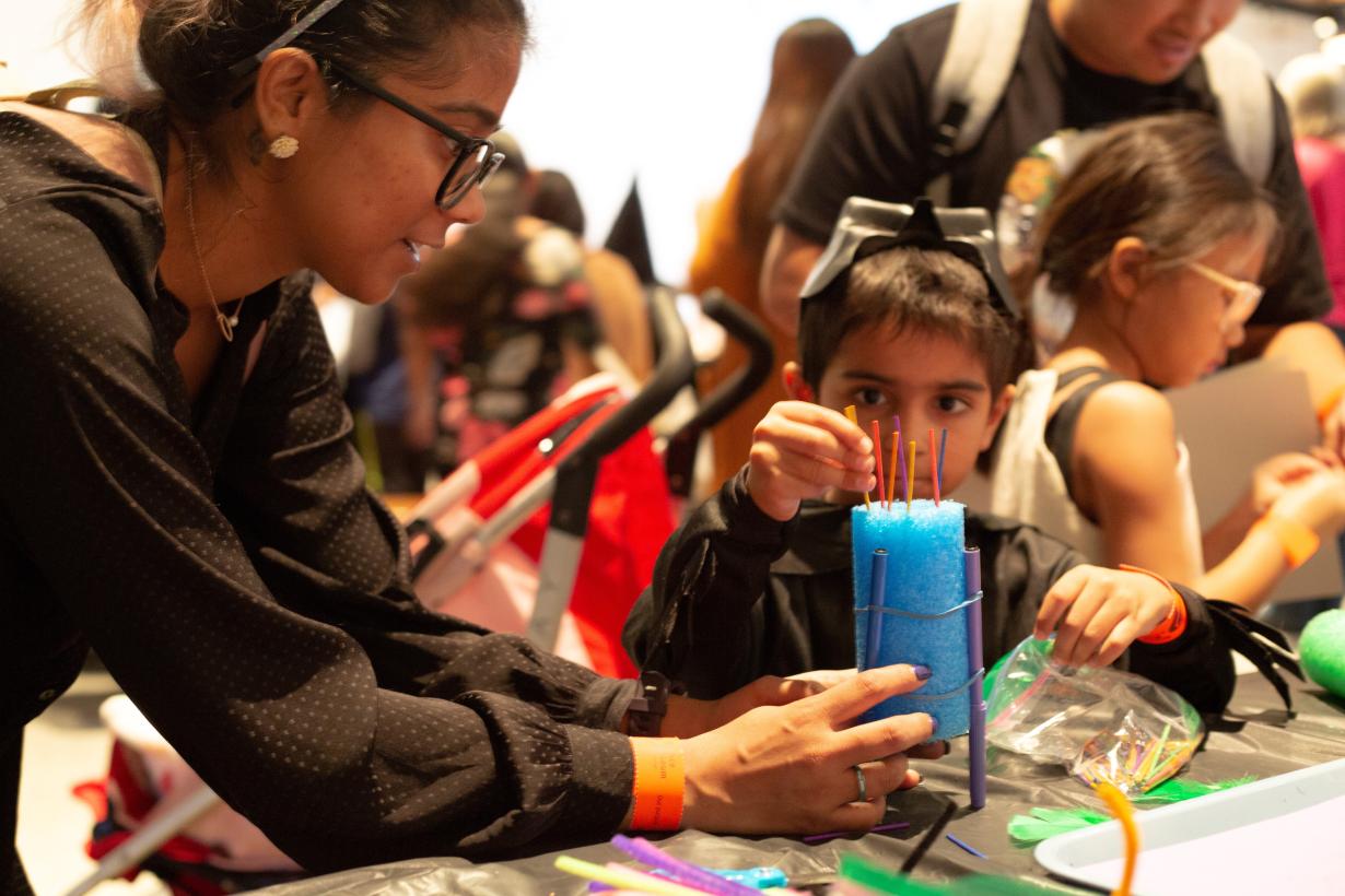 A group of learners creating a scribblebot using a pool noodle, small electric motor and thin markers