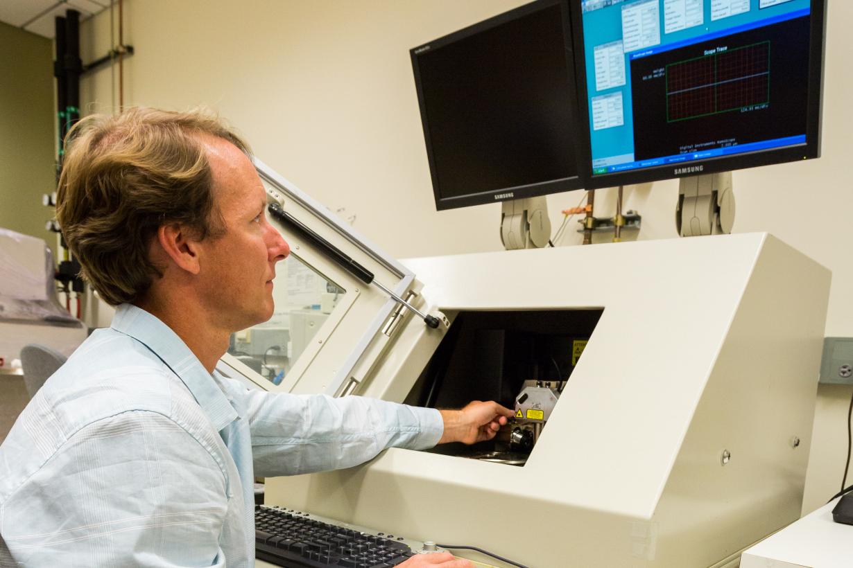 Photograph of scientist using an Atomic Force Microscope (AFM).