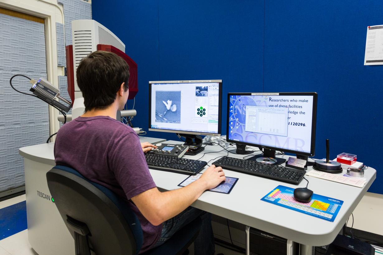 Scientific Image - Scientist using a scanning electron microscope