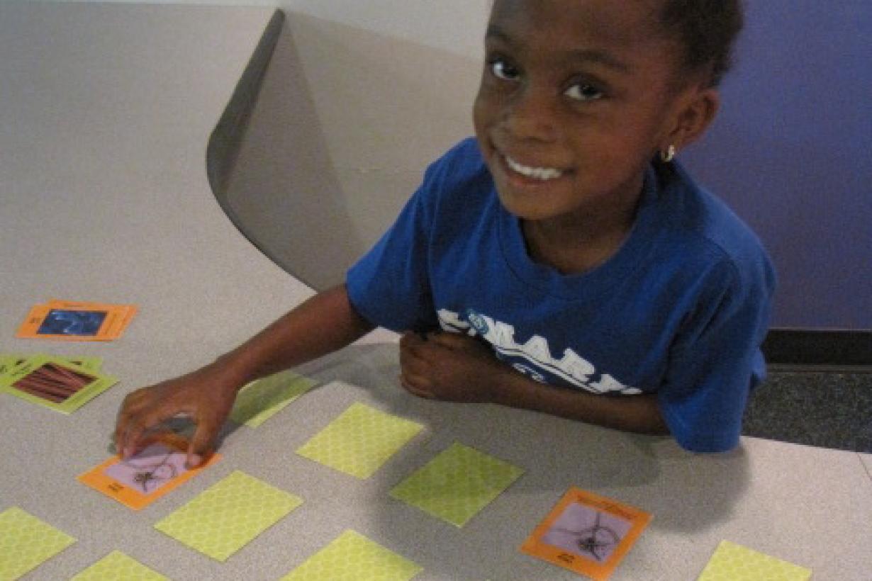 A girl playing the Exploring Size - Memory Game