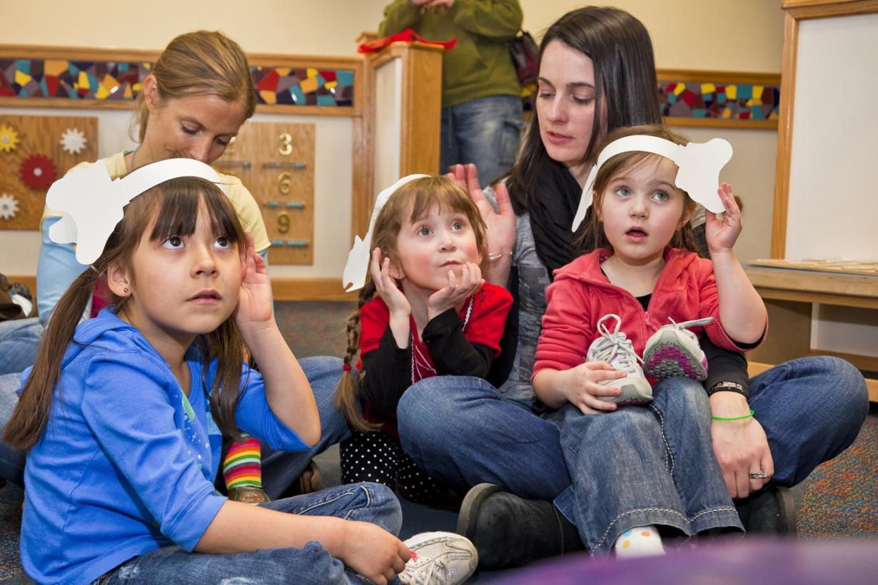 A family pays attention to a the story of "Horton Senses Something Small"