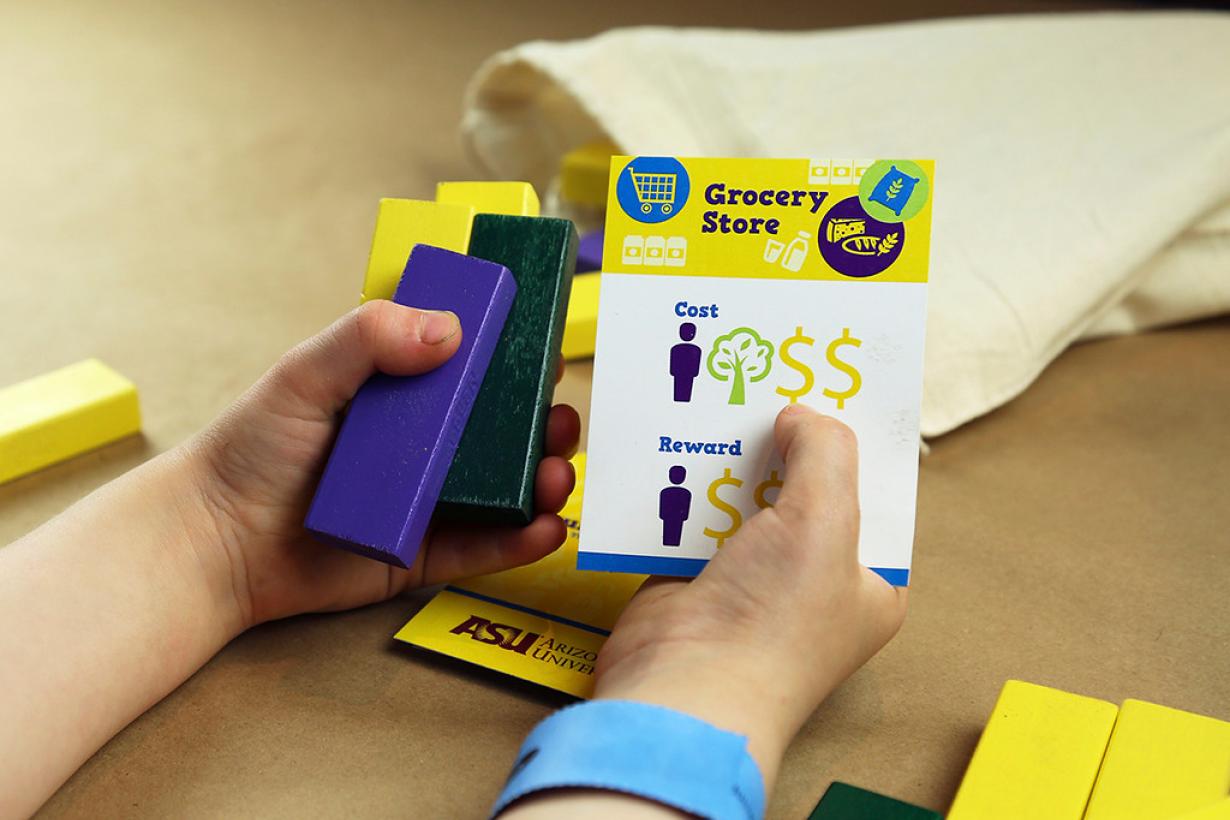 Hands holding blocks and cards for Future Builder SustainABLE activity