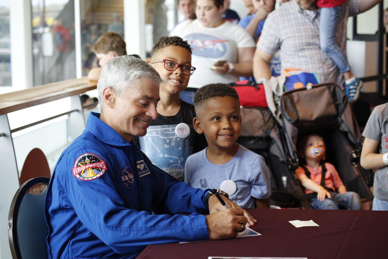 NASA Astronaut Mark Vande Hei at Science Museum of Minnesota 2019 Moon Landing anniversary event signing autographs for visitors