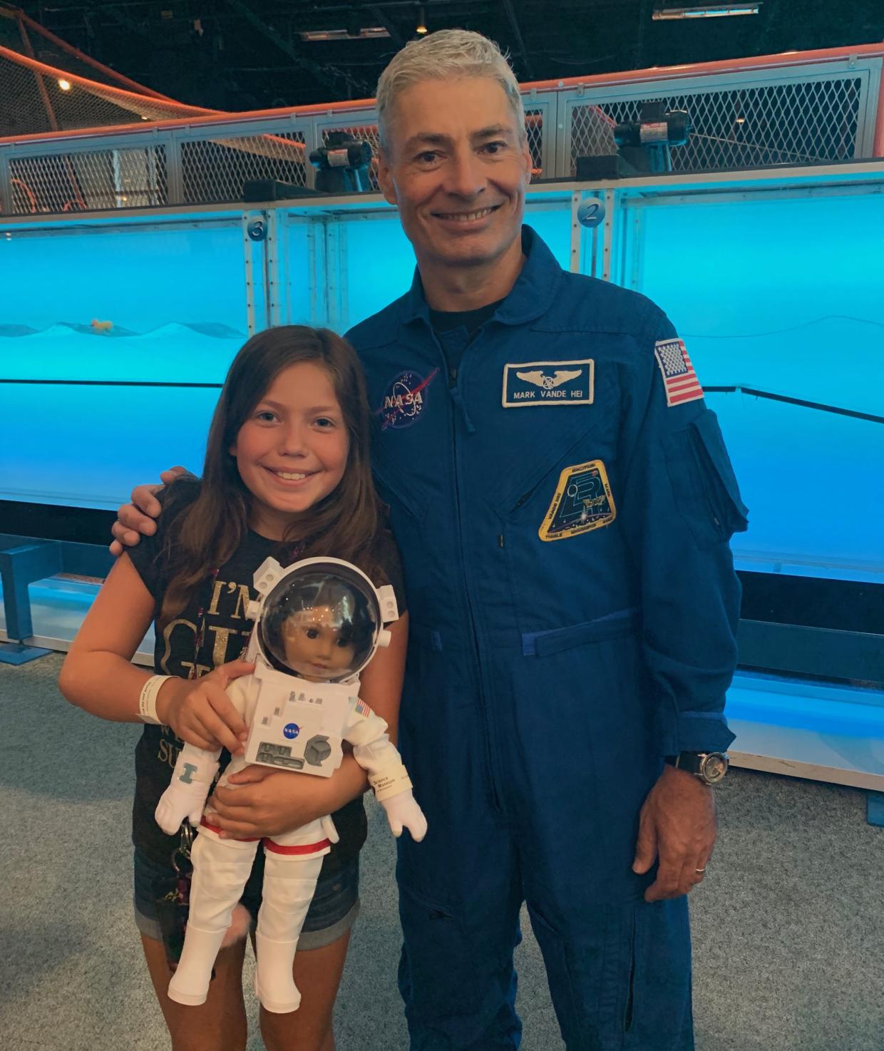 NASA Astronaut Mark Vande Hei at Science Museum of Minnesota 2019 Moon Landing anniversary event with girl holding American Girl Doll astronaut doll