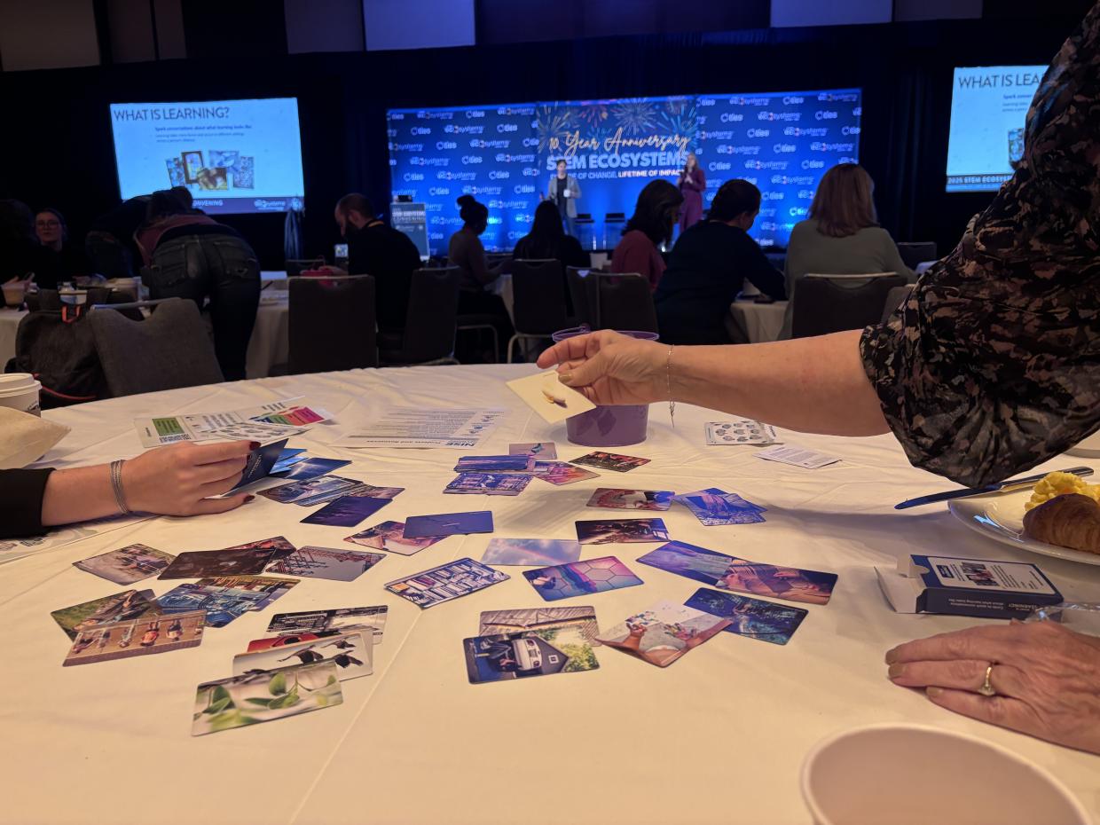 What is Learning cards spread out on a table at STEM Ecosystems convening October 2025