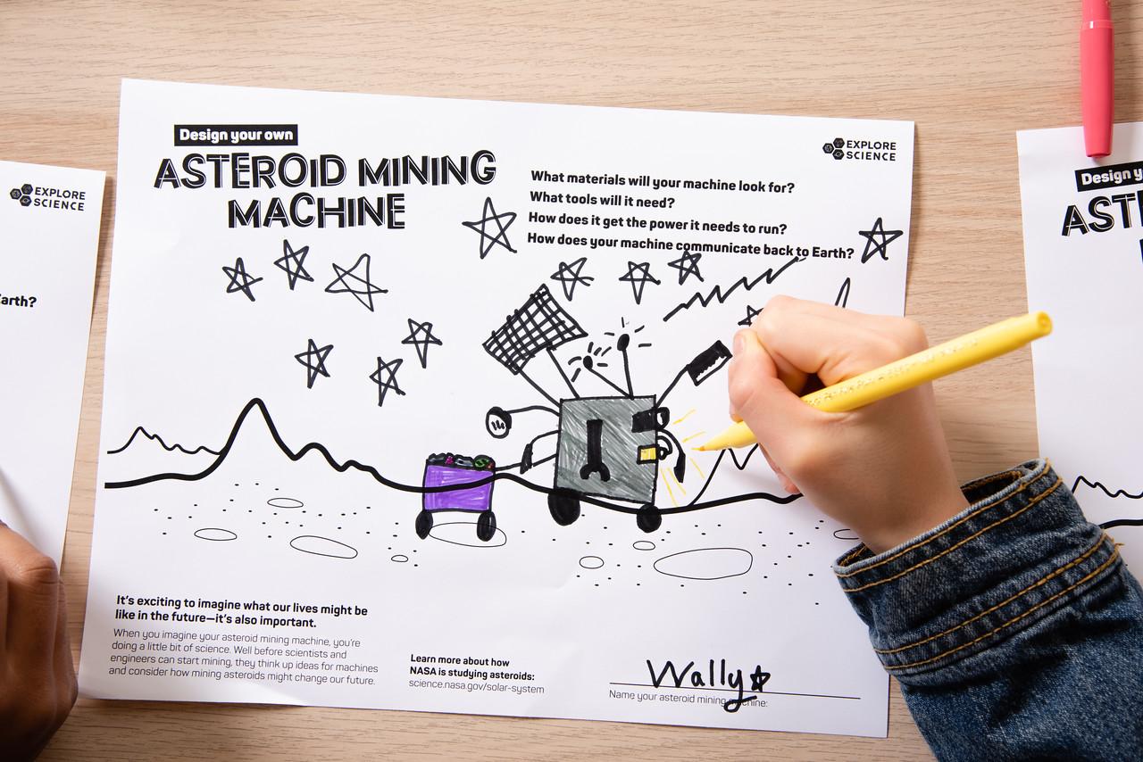 Asteroid Mining hands-on activity child's hand holding pencil drawing a picture