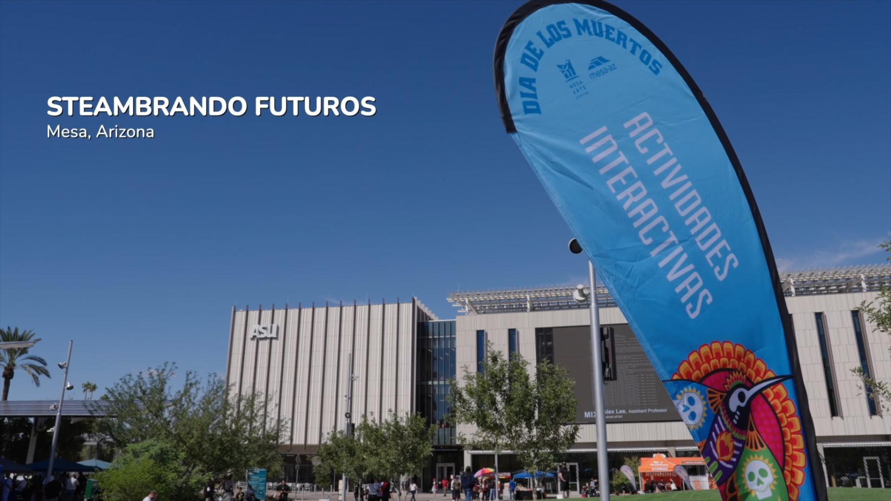 A clear blue sky behind a building with a sign reading "Actividades Interactivas"