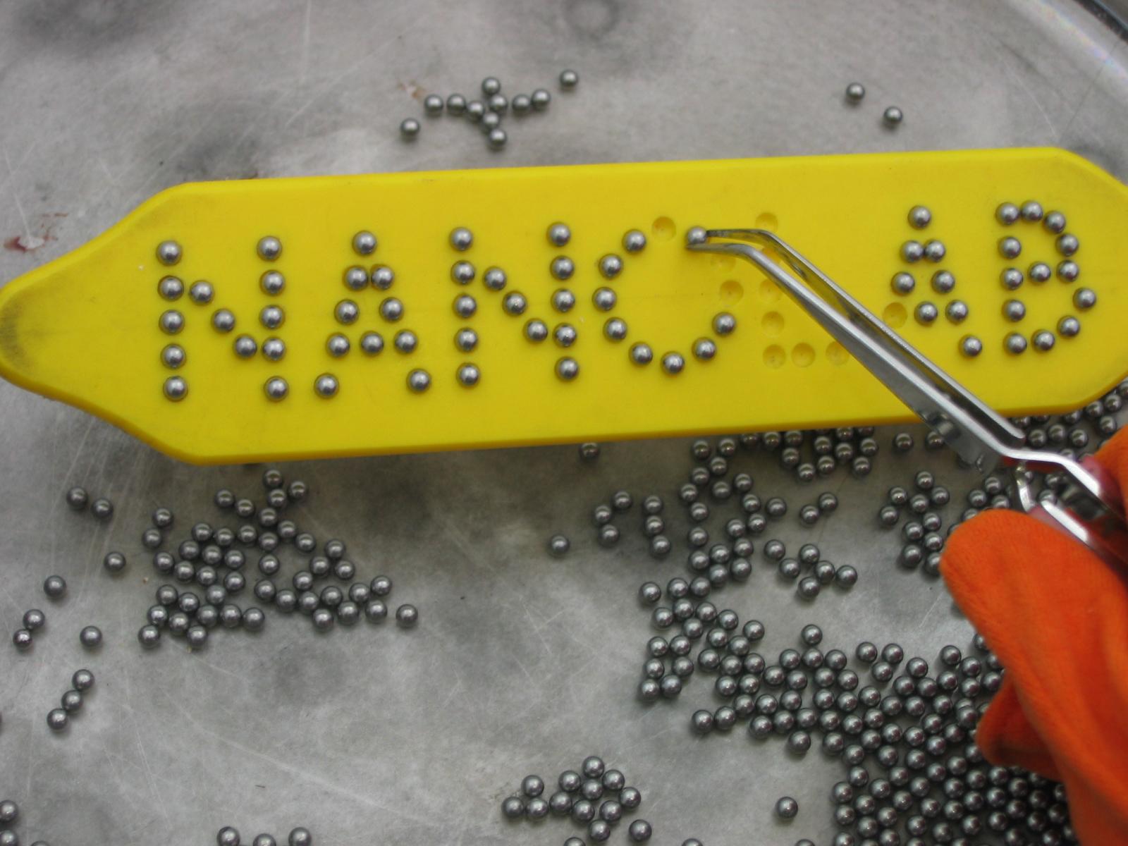 NanoLab exhibit magnets being arranged into the work Nanolab