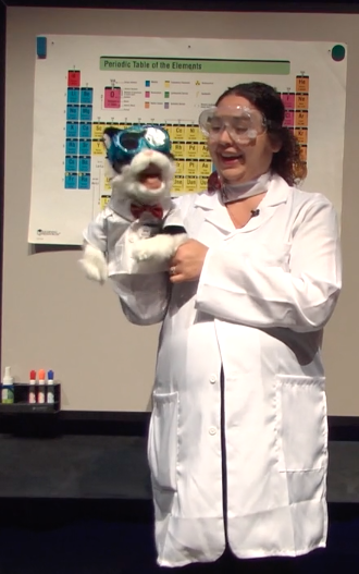 chemistry training video screenshot with presenter and chemistry cat puppet