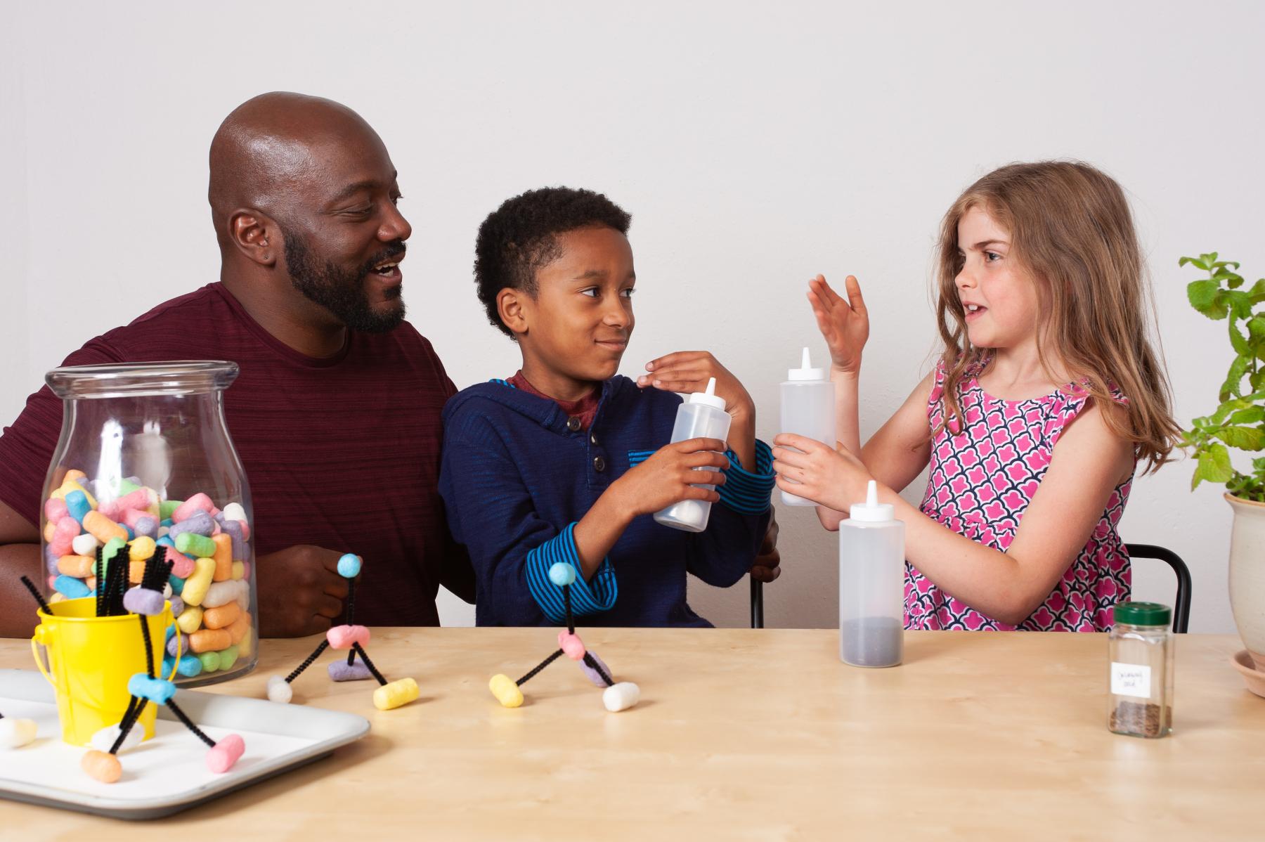 Adult and children sensing and discussing odors in Chemistry Makes Scents activity