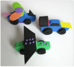 Three flying car models made out of small foam pieces