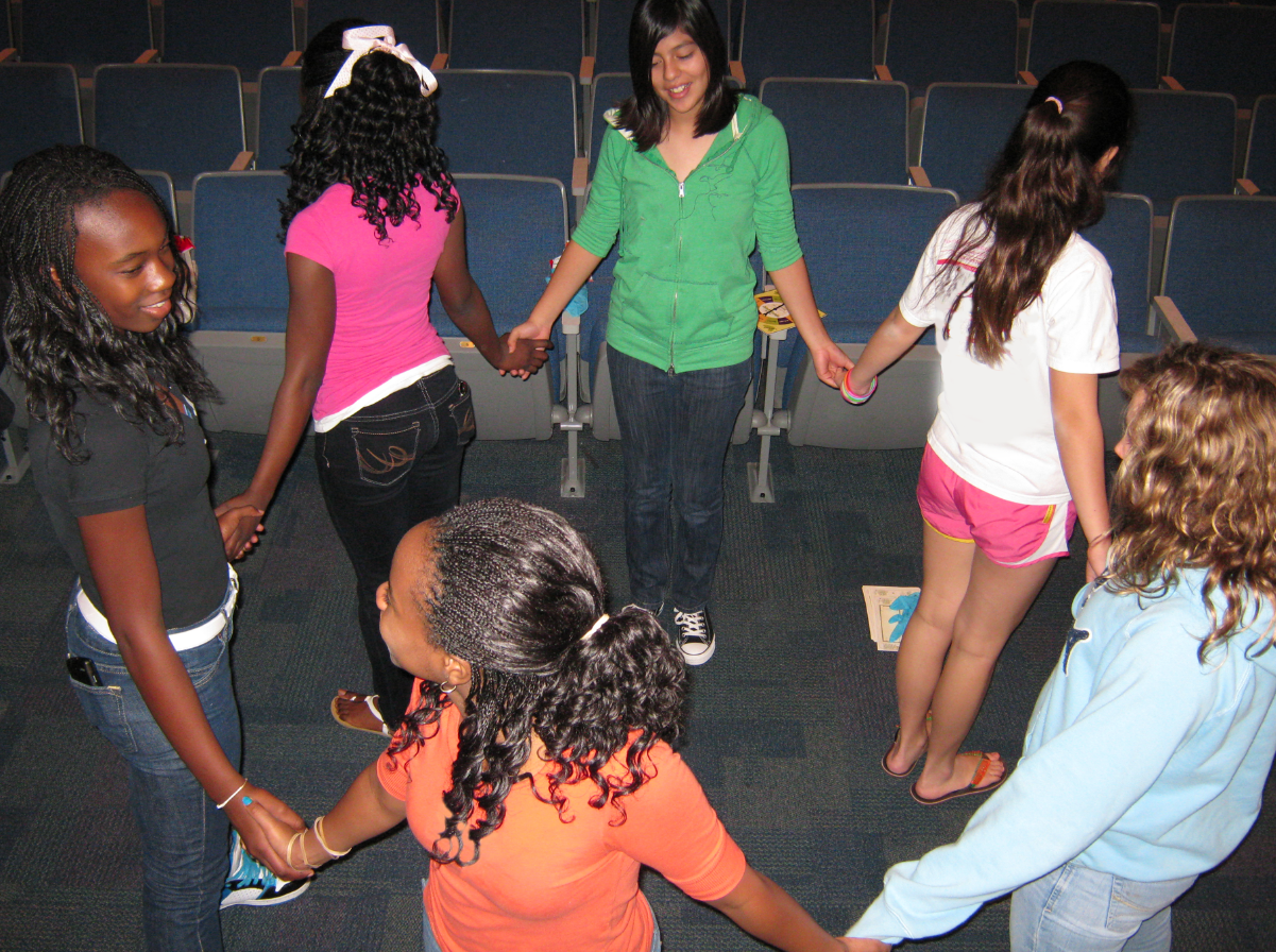 A group of learners holding hands in a self-assembly game