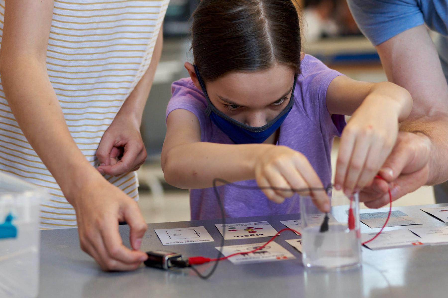 Moon Adventure Game players working on electrolysis challenge using battery and alligator clip wires