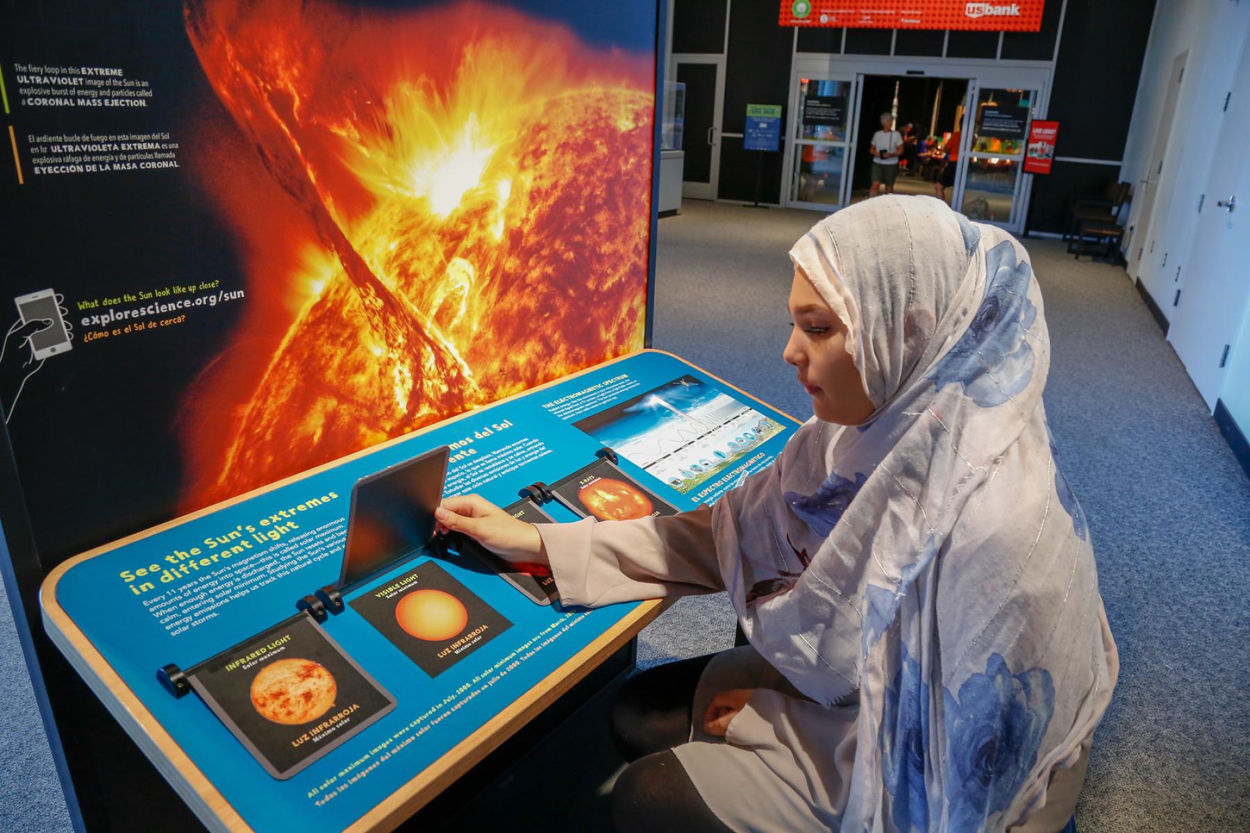 Sun Earth Universe visitors using Sun exhibit flip doors