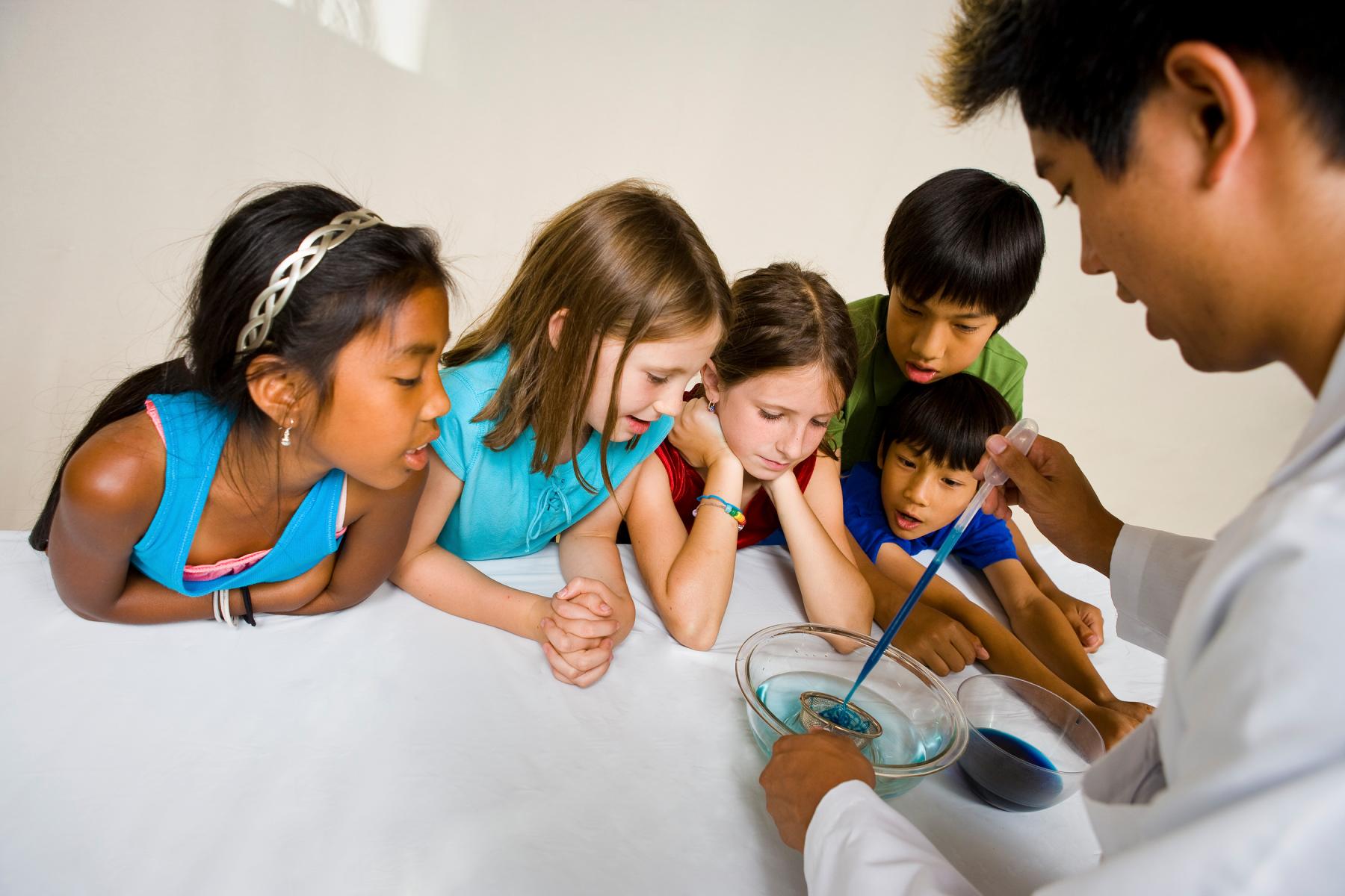 Educator and group of children learning about self assembly using Gummy Capsules NanoDays activity