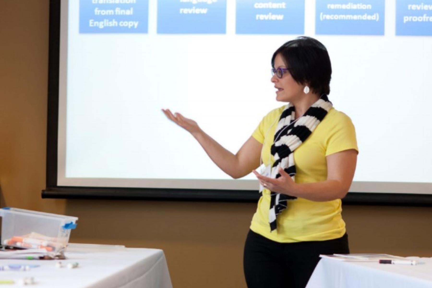 educator in yellow shirt giving a presentation