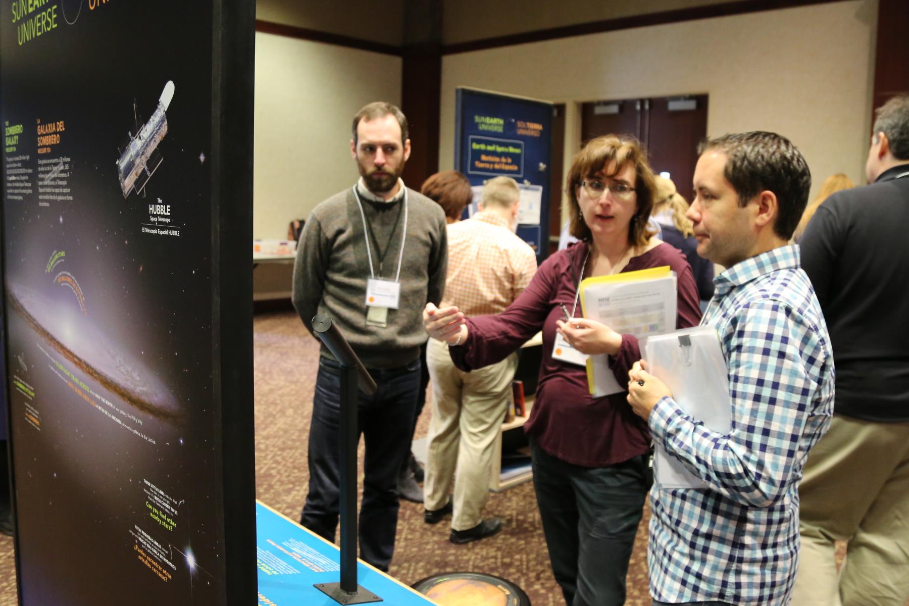 Experts discussing a museum exhibition component prototype at a professional meeting