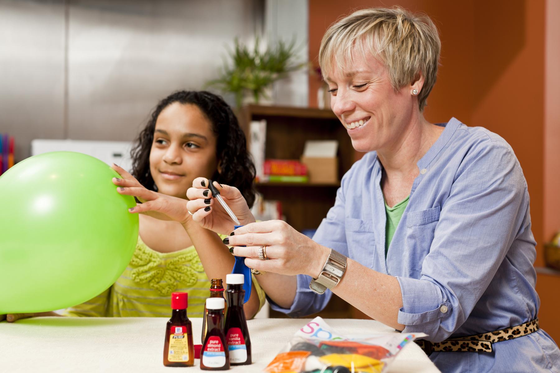 A facilitator adds scented oils into deflated balloons