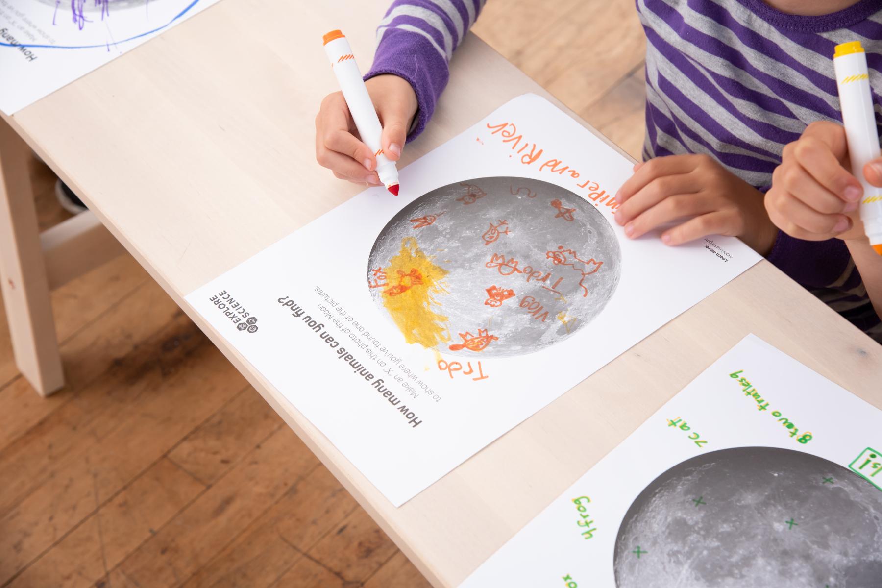Learner records/draws what she sees on the moon poster from a distance