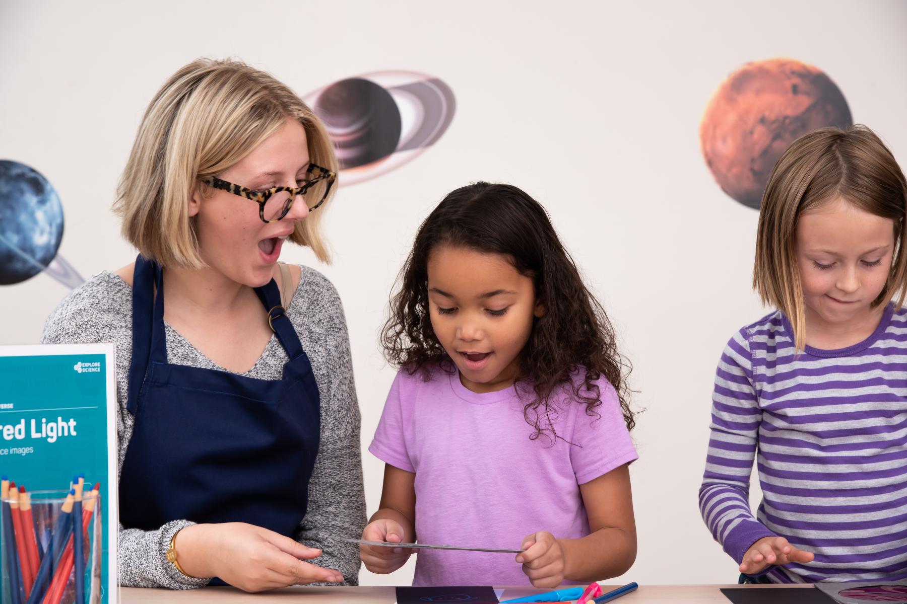 A facilitator and learner use a color filter film on an image