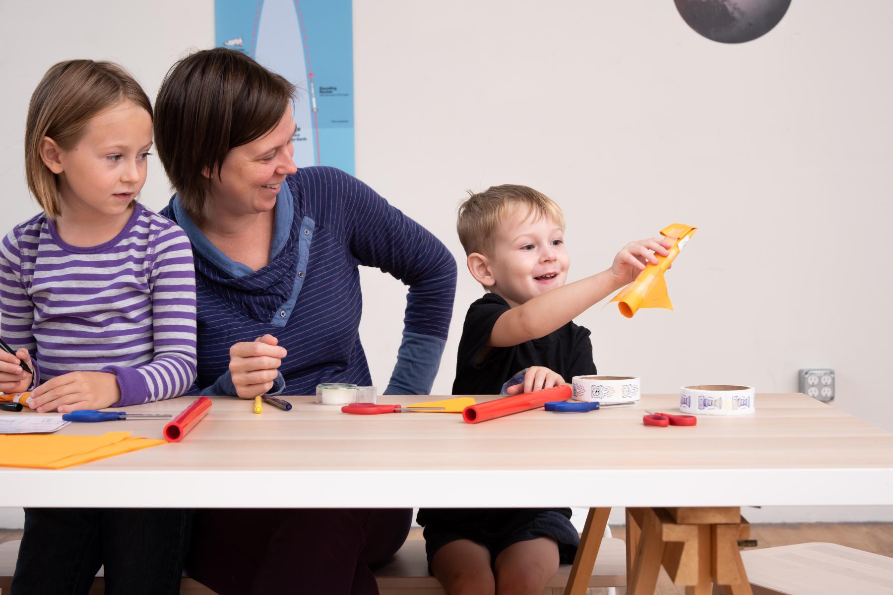 Family showing a newly made paper rocket