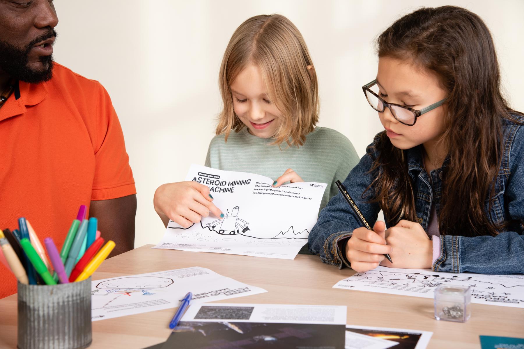 Learner shows their mining drawing to a group