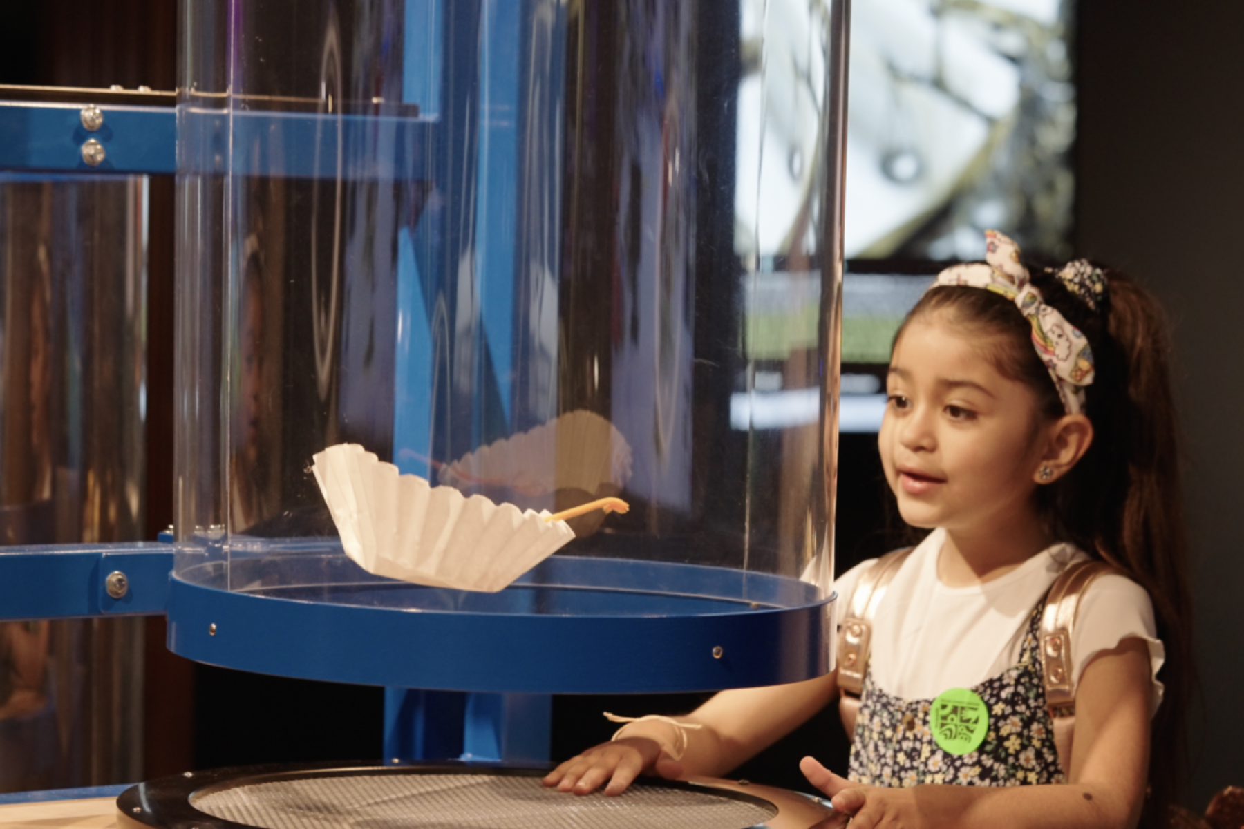 Young Mission Future exhibition visitor interacting with air tube