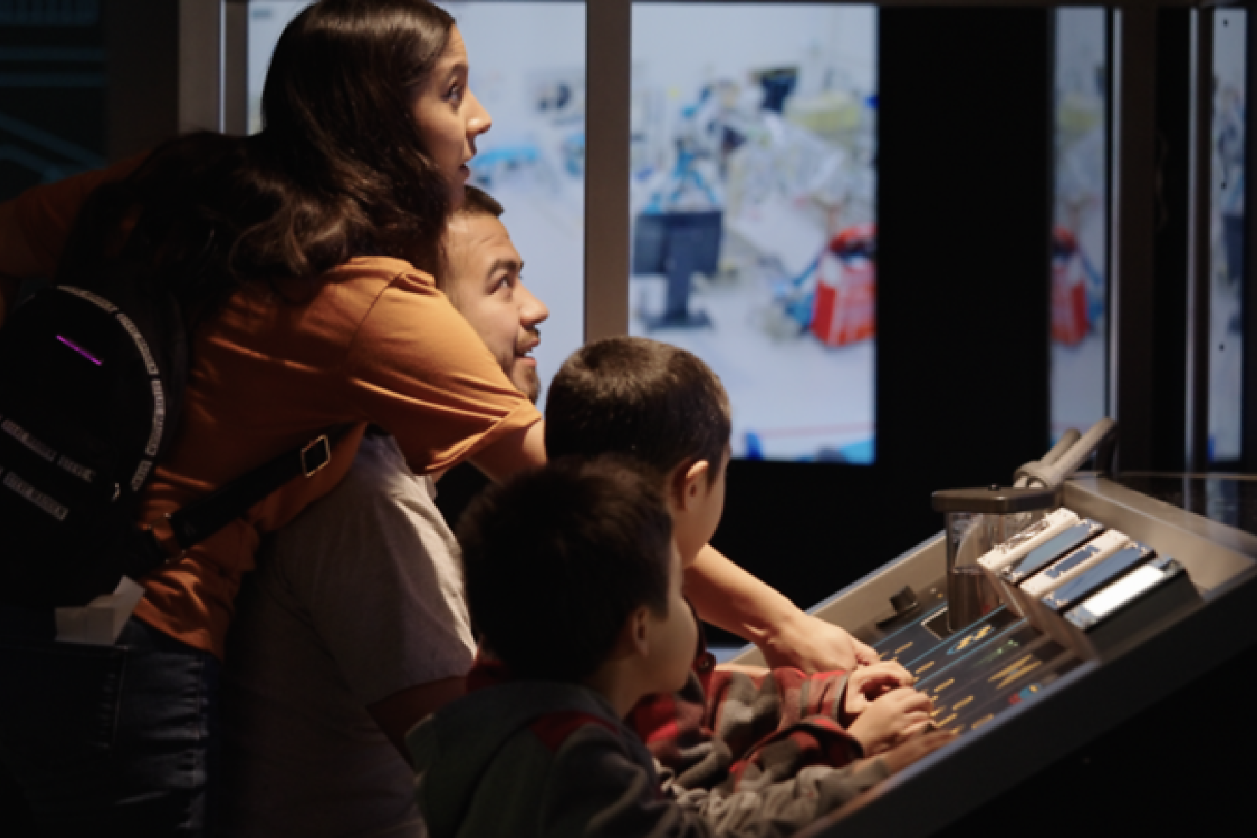 Family interacting together with Mission Future exhibition