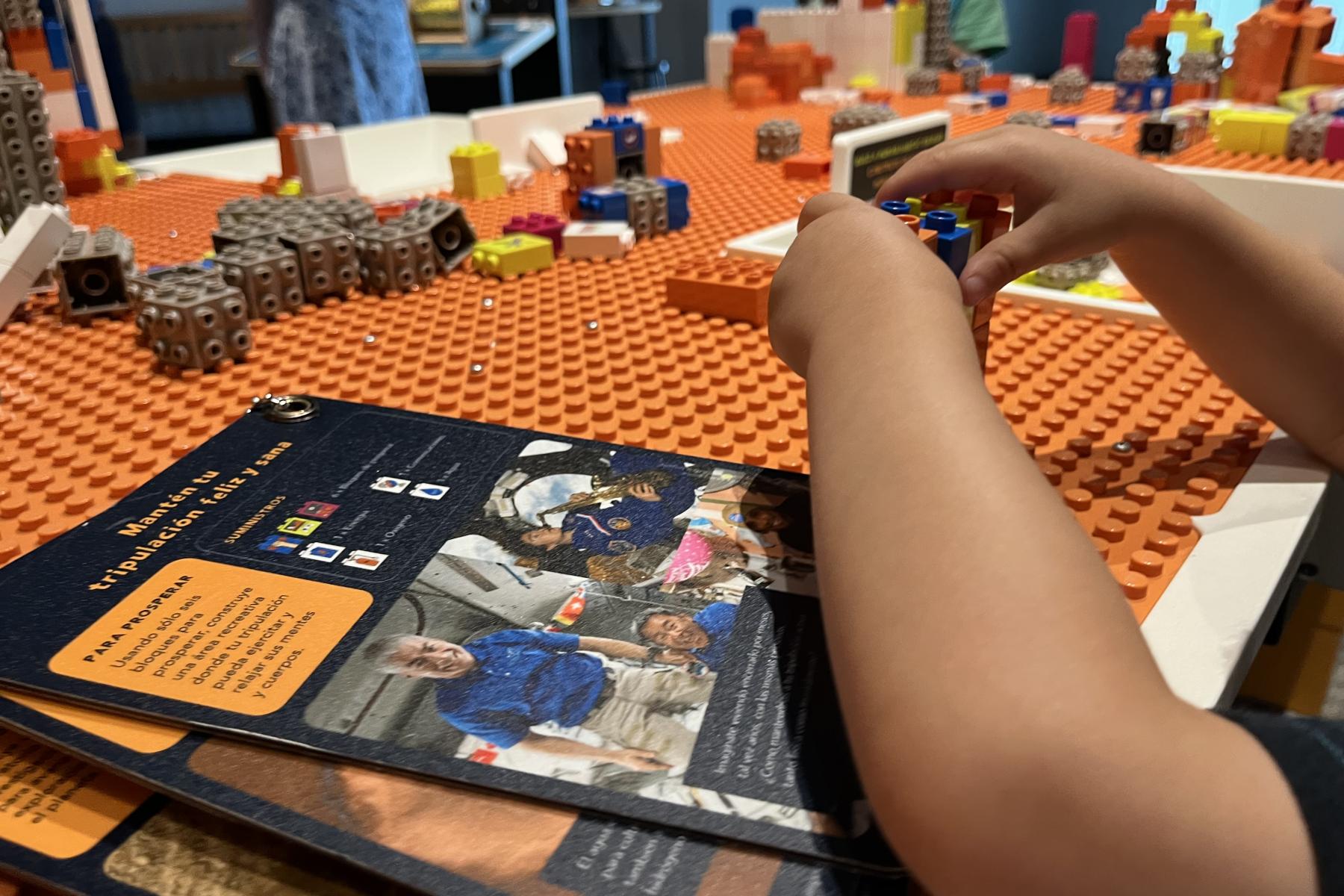 Build a Human Habitat on Mars - child building with bricks next to challenge cards