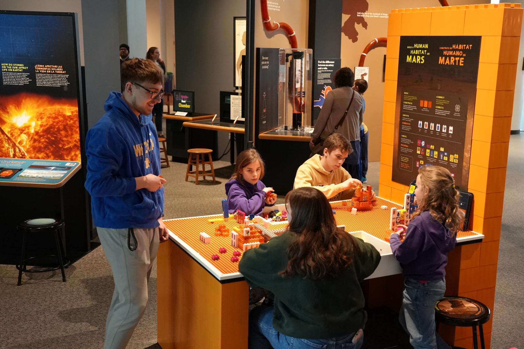 Build a Human Habitat on Mars group of visitors building with bricks 