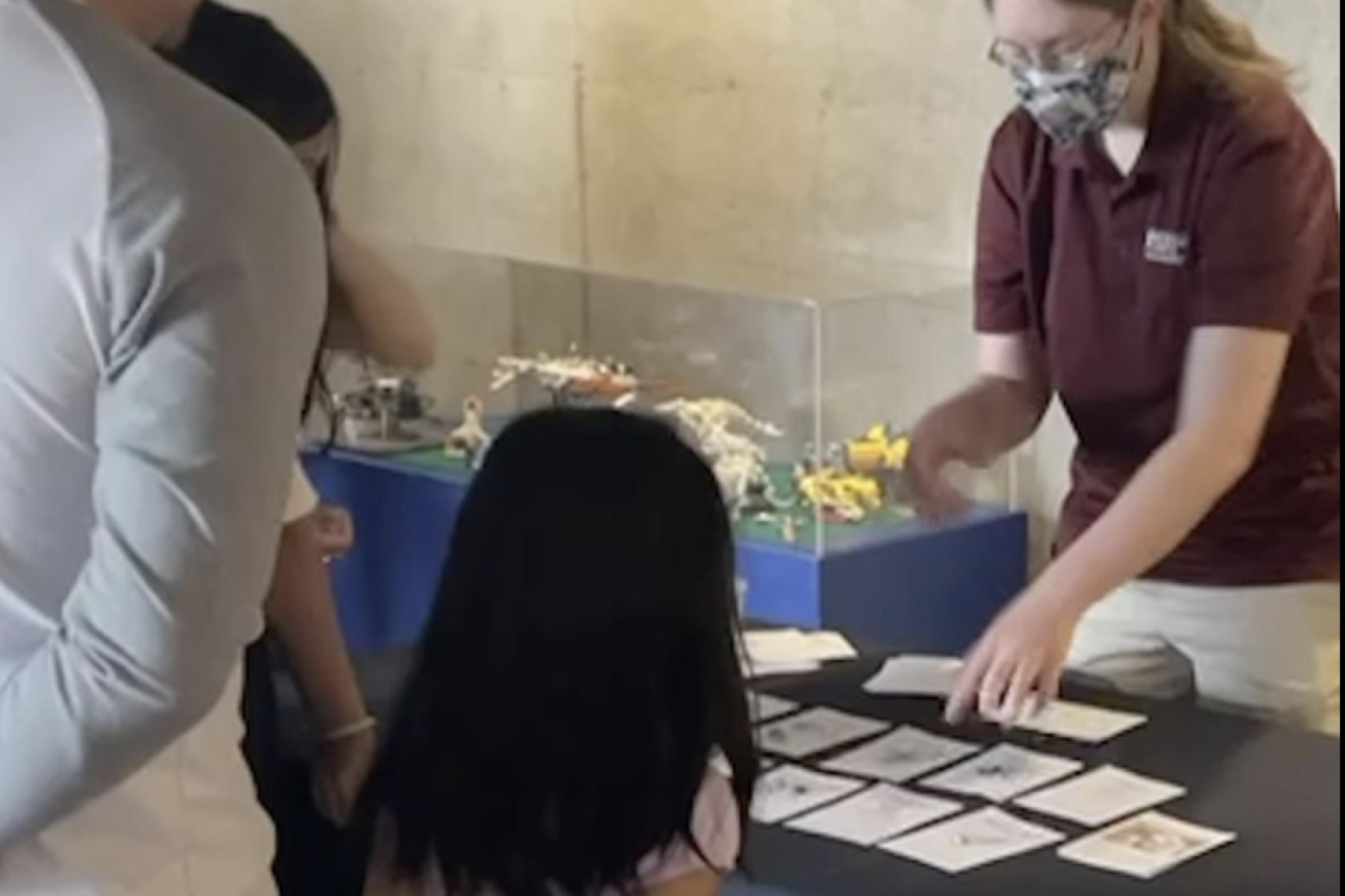 Changing Brains Neuro Futures Card Game with masked facilitator working with a child and caregiver