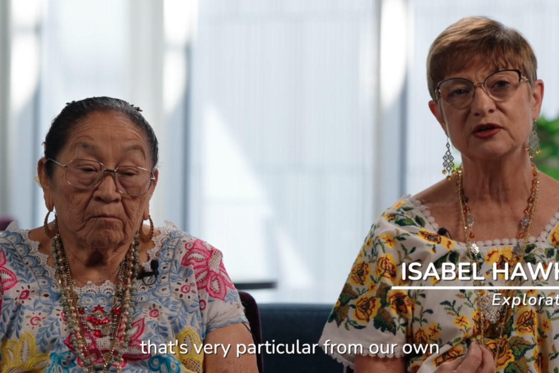 Two individuals sit for a filmed interview, the person on the right is speaking. 