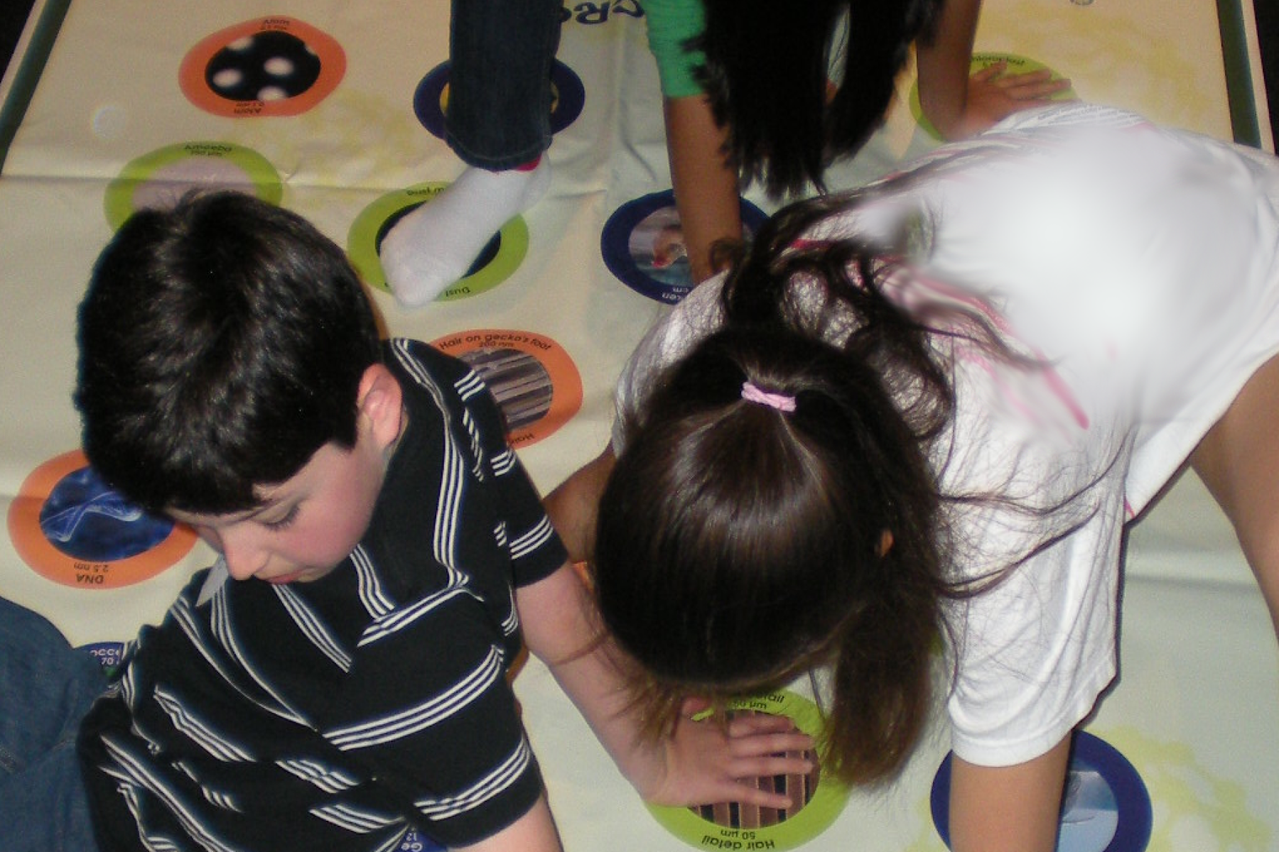 Three kids playing on the Nano Stretch-Ability mat