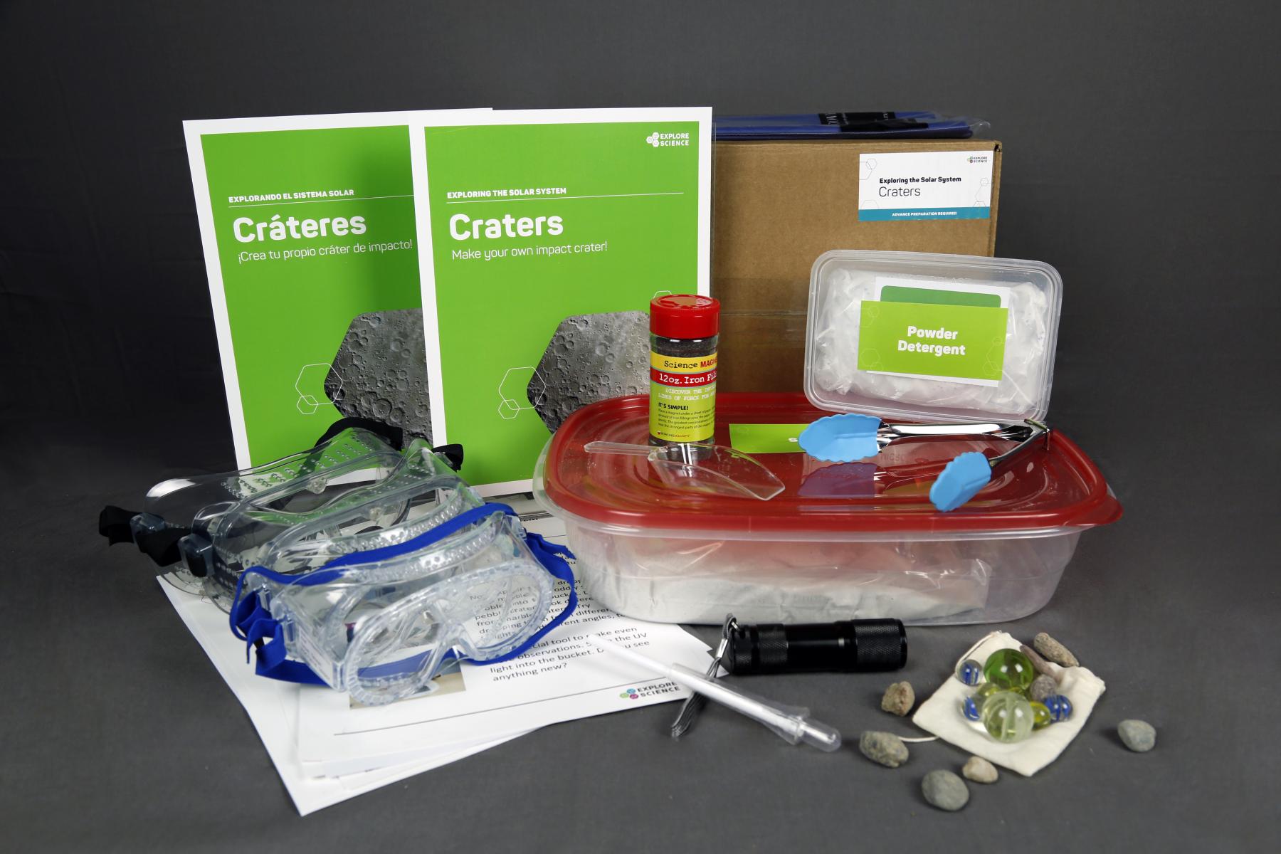 Image of the various contents of the Crater kit, including sand, weights, and other objects