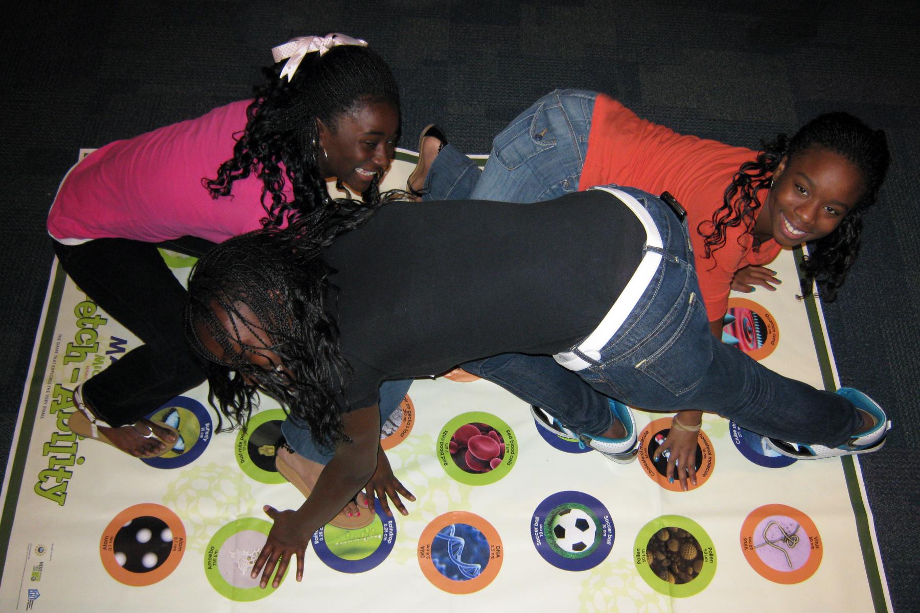 Three girls playing on the Nano Stretch-Ability mat