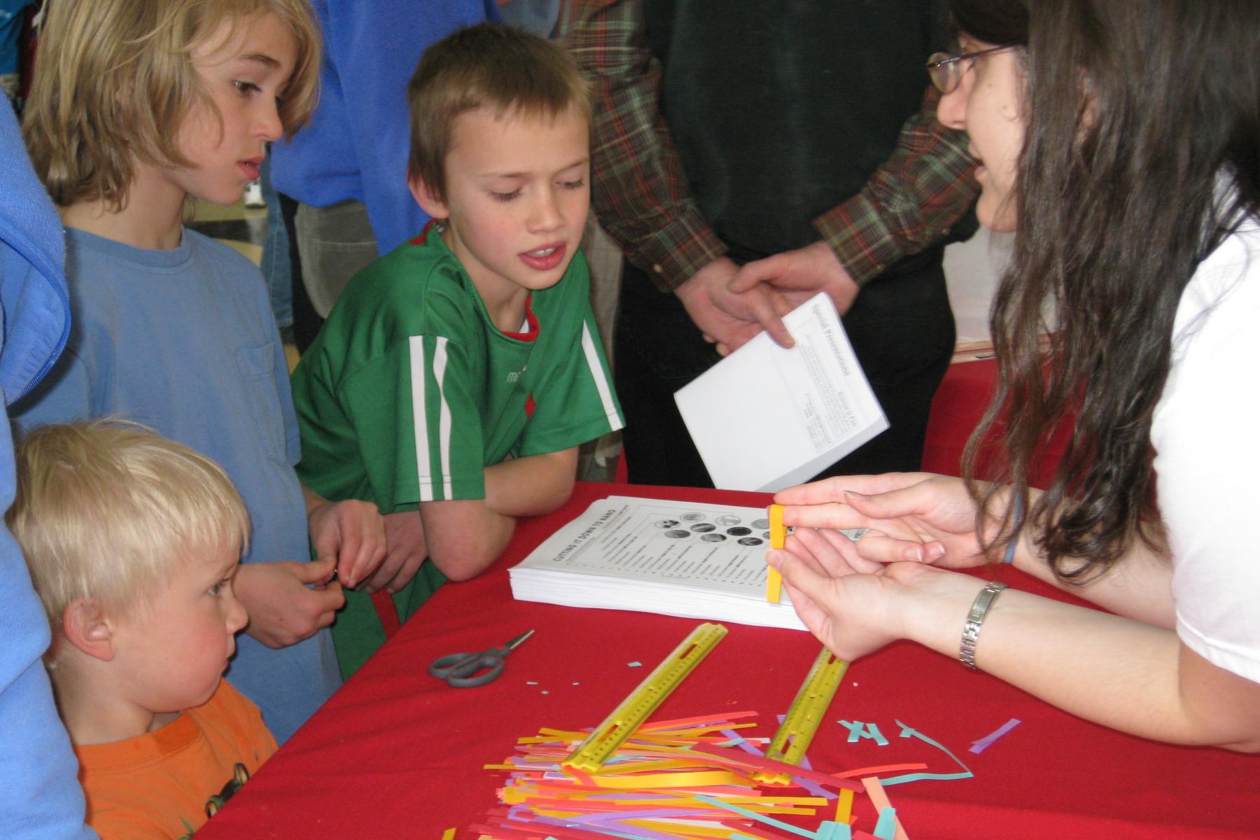 A Facilitator explains the activity to a group of learners 