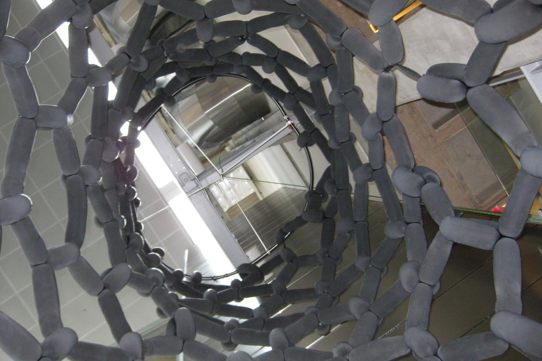 Inside of a balloon model of a carbon nanotube looking up.