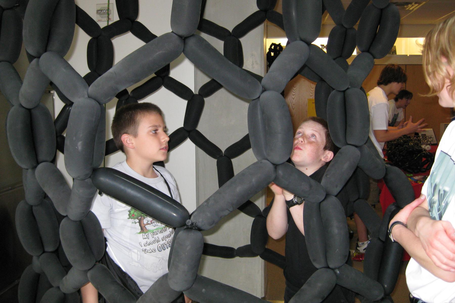 A person inside of a balloon model of a carbon nanotube.