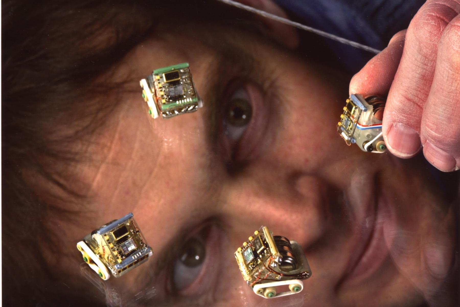 A person with computer chips stuck on their face