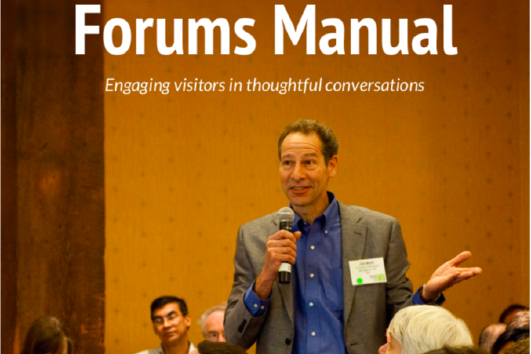 forums manual cover featuring a man with a microphone in an audience asking a question