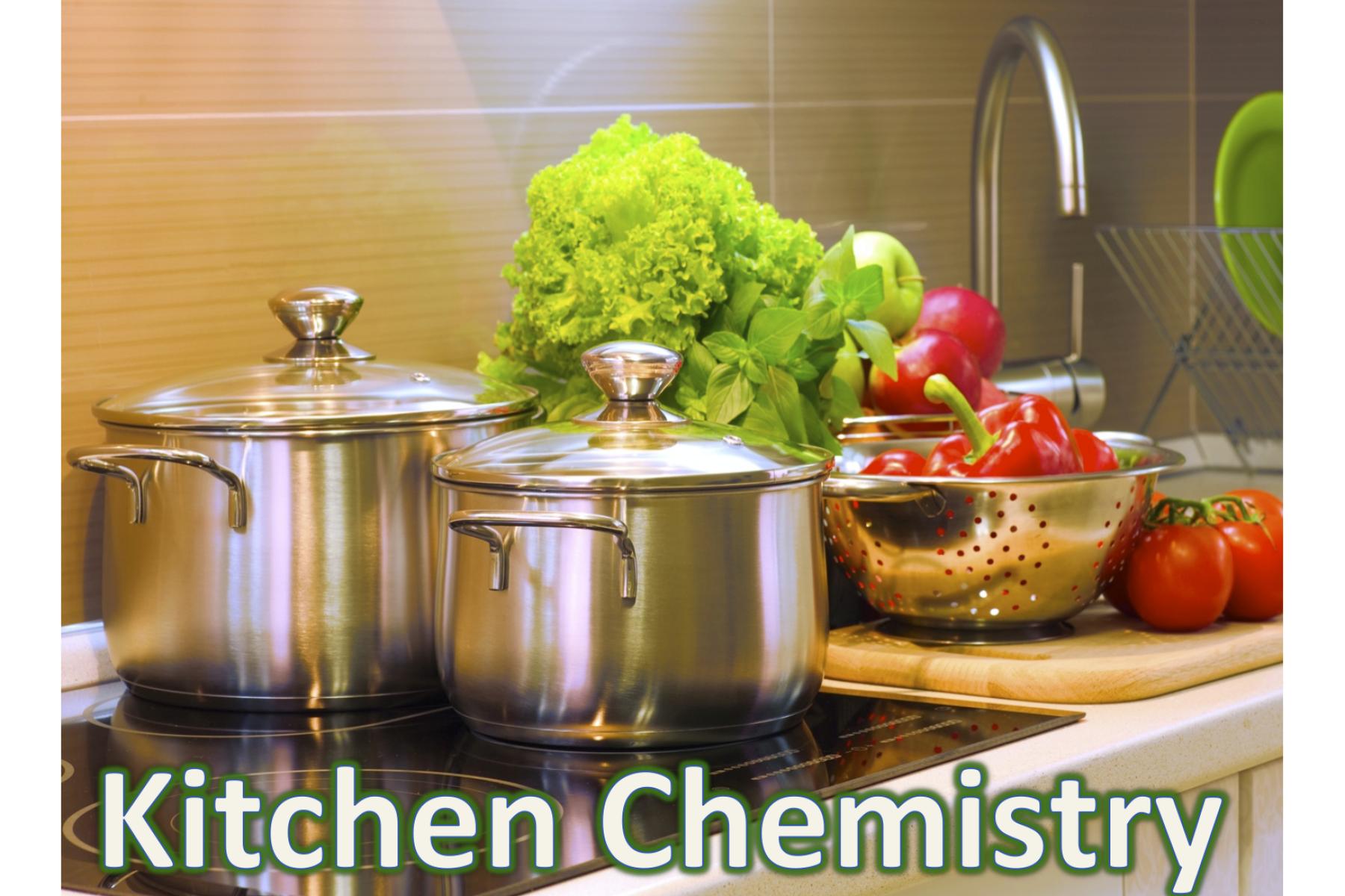 Pots on a kitchen stovetop next to vegetables on a kitchen counter