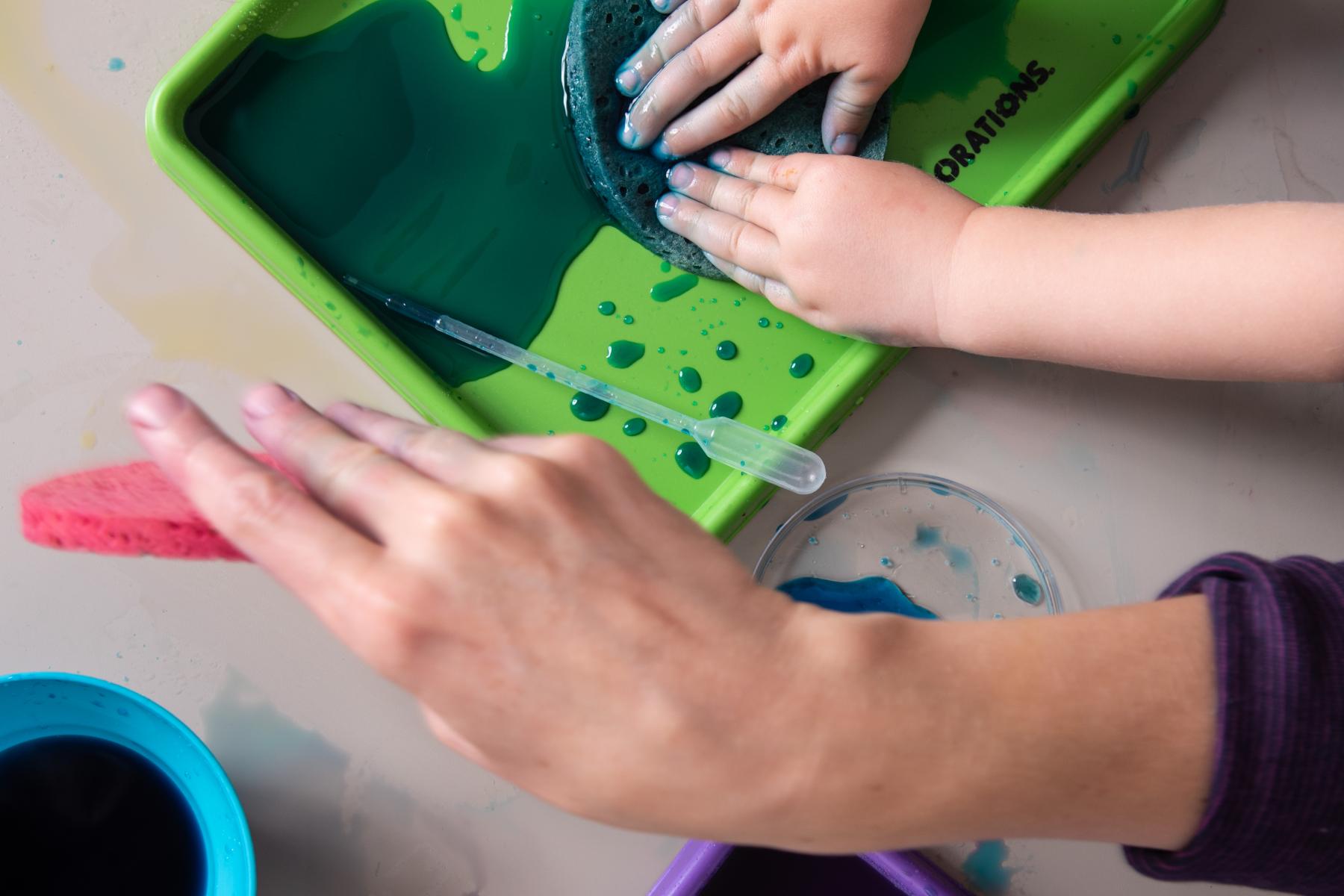 Young learners use sponge to absorb water