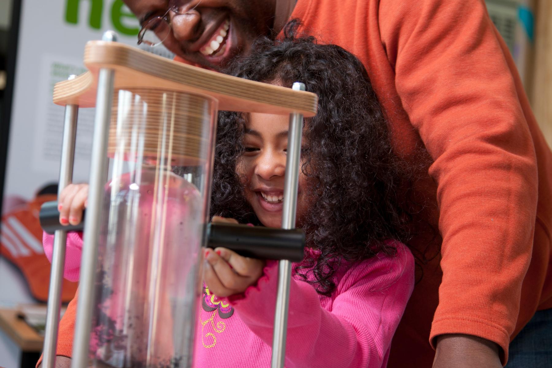 Father and child using the ferrofluid exhibit Small Smaller Nano exhibition the Nano exhibition