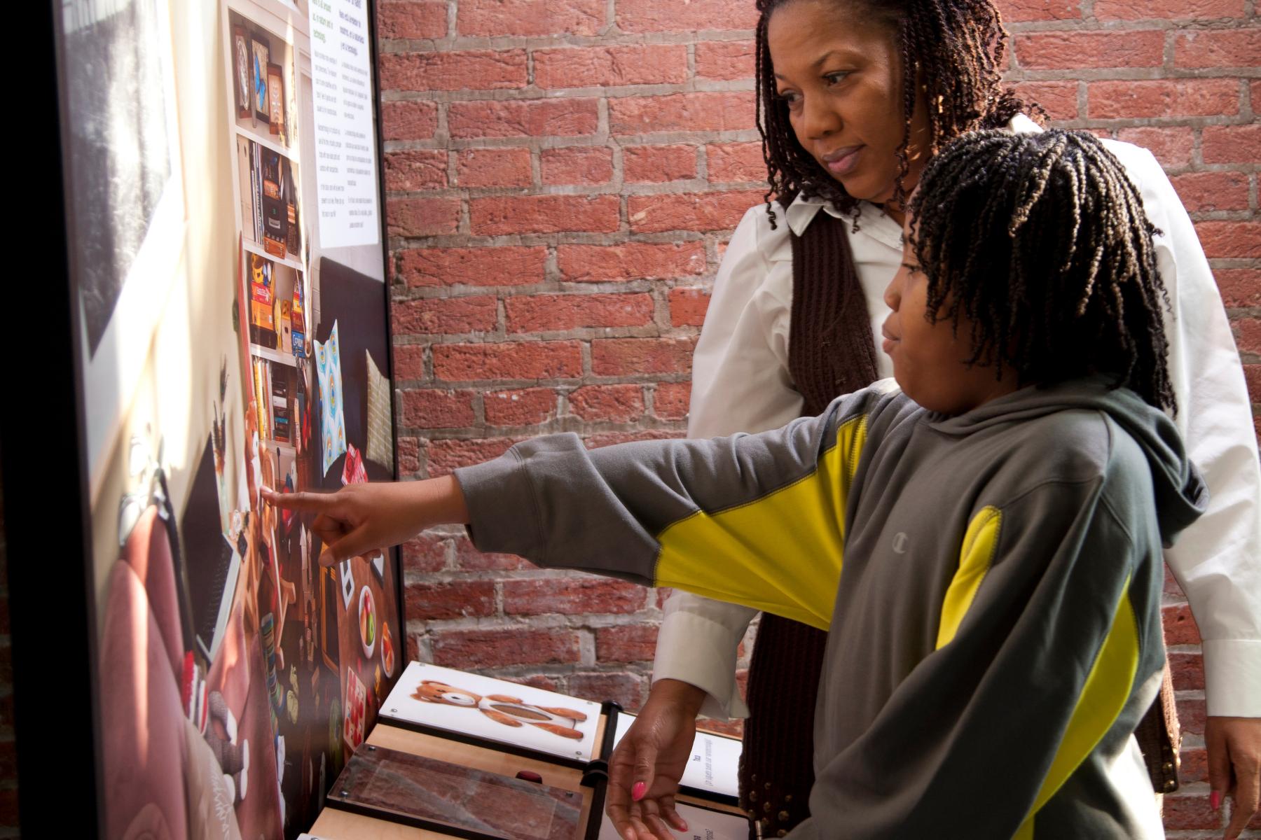 Mother and child using the I Spy Nano exhibit in the Nano exhibition