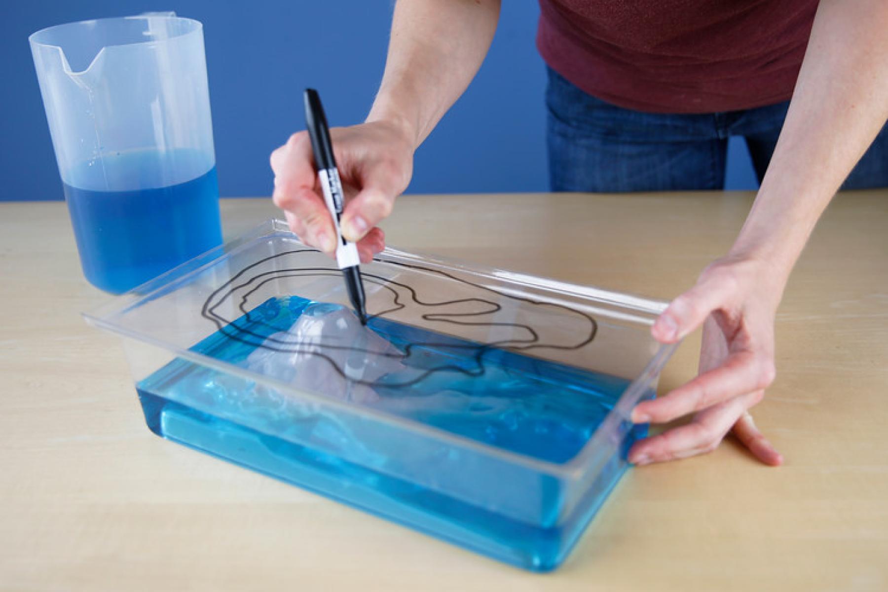 Rising Sea activity showing hands drawing contour lines on plastic box