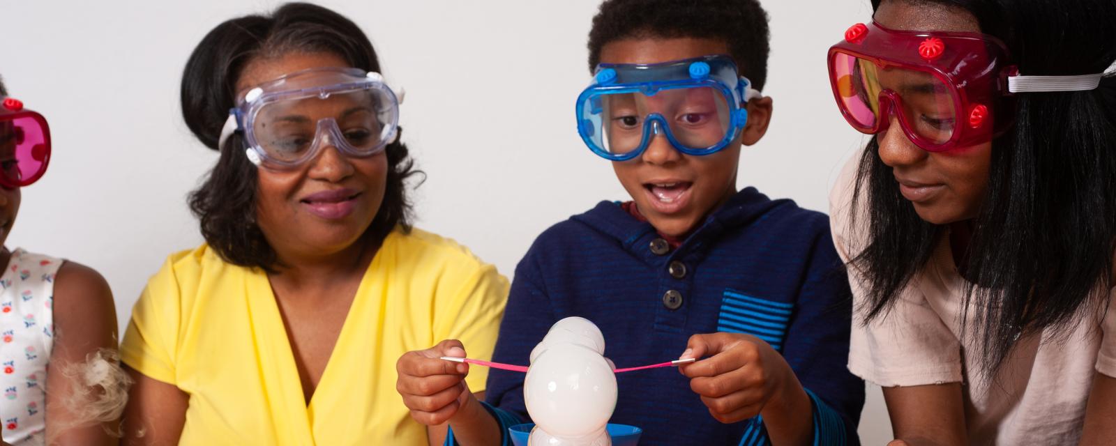 Mother and two children using dry ice to make a cloud in Sublimation Clouds Explore Science Let's Do Chemistry activity