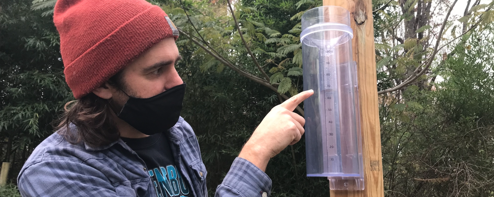 Citizen scientist taking a precipitation measurement on a CoCoRaHS rain gauge